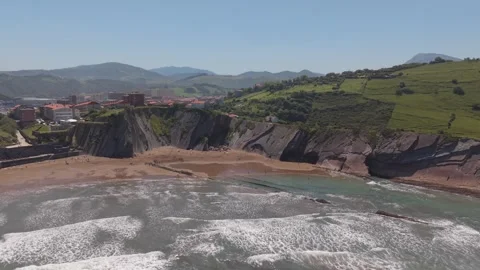 Aerial view of flysch rock strata along a green coastal bay Stockbeeldmateriaal 343324412