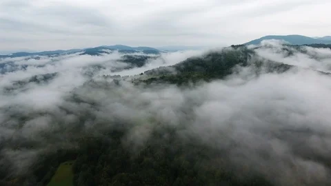 Aerial View of Fog Among the Mountain Peaks. Bad Weather and Fog Stock Footage