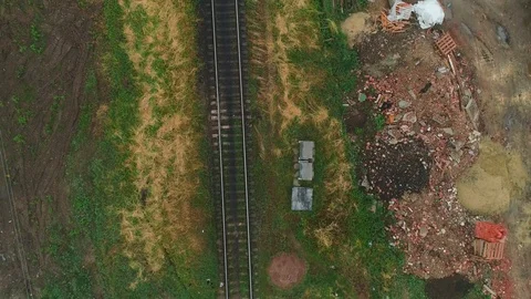 Aerial view of following old rusty abandoned rail tracks. 4K. Stock Footage 110714250