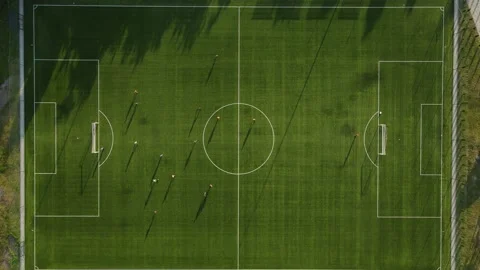 Aerial view of football club training. Big shadow on field. Stock Footage