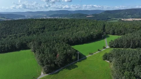 Aerial view of forest and mountains near village, Germany. Stock Footage 284855535