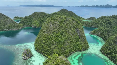 Aerial View of Forest-Covered Limestone Islands and Reefs in Raja Ampat Stock Footage 240047463