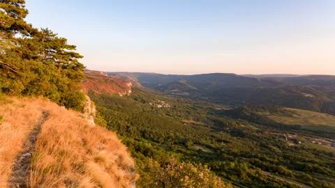 Aerial view of forest gorwing right to the edge of a sheer cliff. Stock Photos