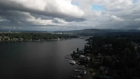 Aerial View of a Forest Lake Under Cloudy Skies Stockbeeldmateriaal 283574553