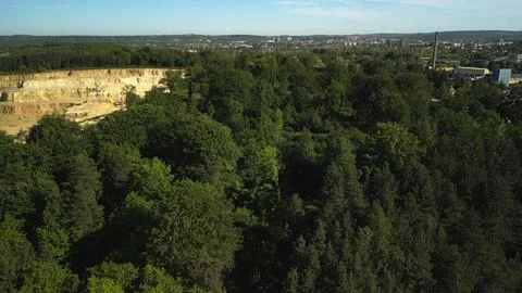 Aerial View of Forest with Open-Pit Dolomite or Limestone Quarry, Blue Sky, and Fotos Stock