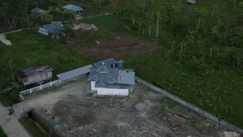 Aerial view of a forest in Papua with sparse resident houses Stock Footage 239507521