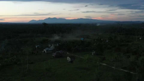 Aerial view of a forest in Papua with sparse resident houses Stock Footage 239520815