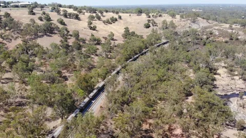 Aerial View of a Forest River Train Stock Footage 139619745