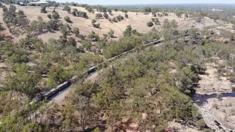 Aerial View of a Forest River Train Stock Footage 139620522