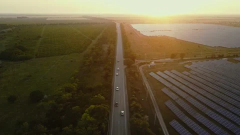Aerial view of forest road surrounded by trees and solar panels. High quality Video stock 156463519