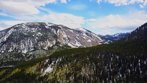Aerial view forest with snow on mountains 4K Stock Footage 80972644