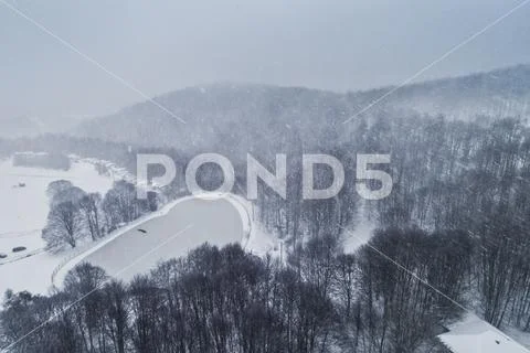 Aerial view of forest in the winter during the snowfall Stock Photos