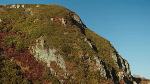 Aerial view of forested caucasus mountain peak colored in autumn colours. sunny Stock Footage 204047506