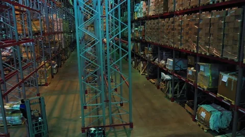 Aerial view of forklifts working between giant metal shelves Stock Footage 113091368