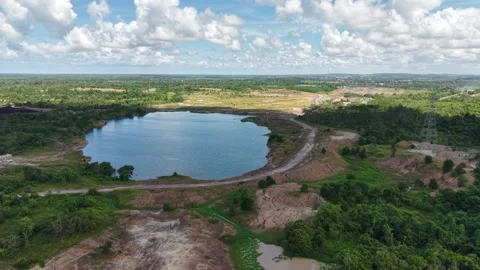 An aerial view of a former coal mine pit filled with blue water, with haul .. Stock Footage 342478920