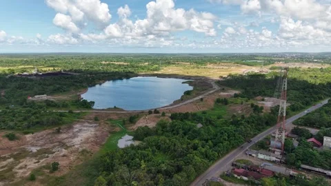 An aerial view of a former coal mine pit filled with blue water, with haul .. Stock Footage 342478929