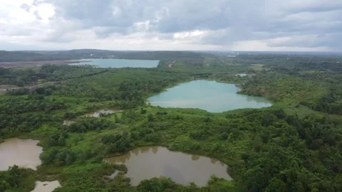 Aerial view of a former coal mining pit that holds water like a blue lake, .. Stock Footage 325644308