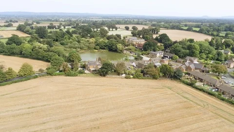 Aerial view, forward move. Christleton old houses next to pond. Traditional v Stock Footage 95554997