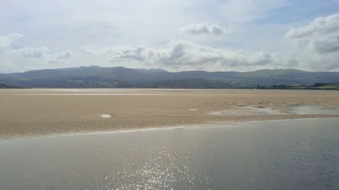 Aerial view, forward move. Drone panorama on slowly moving water, sea and san Stock Footage 94234472