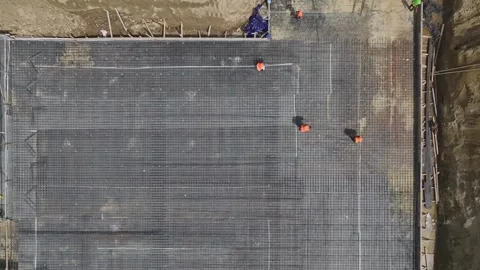 Aerial View: Foundation insulation and heavy metal reinforcements are carried Stock-Footage 296096385