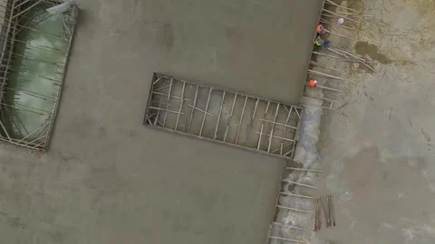 Aerial View: A foundation takes form as concrete is poured and engineers Stock Footage 296084366