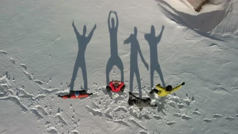 Aerial view of four large shadows in the snow. Travelers dance and show various Stock Footage 158742790