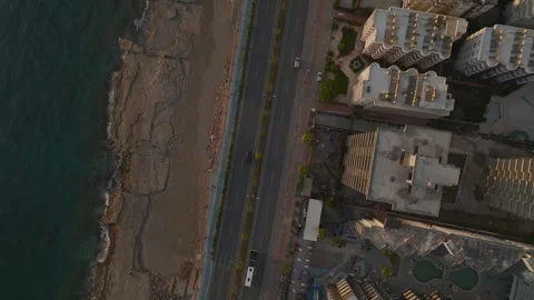 Aerial View: The framework of a high-rise structure on the beachfront shows the Stock Footage 296078808