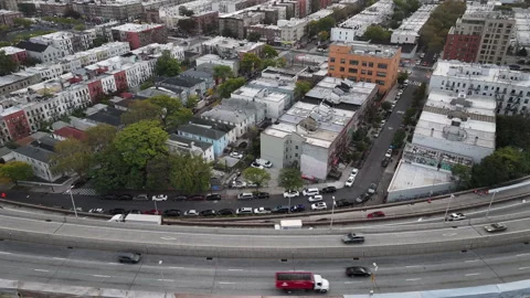 Aerial view of a freeway cutting through Brooklyn Stock Footage 253981725