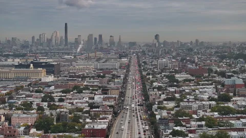 Aerial view of a freeway cutting through Brooklyn Stock Footage 253982705
