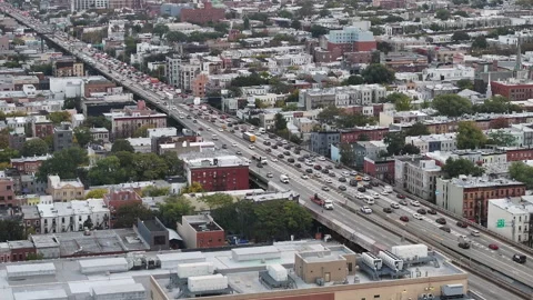 Aerial view of a freeway cutting through Brooklyn Stock Footage 253983646