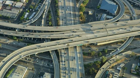 Aerial view freeway interchange vehicles travelling around LA Stock Footage 95991201