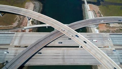 Aerial view of an freeway intersection junction on a sunny day with cars Stock Footage 111605932