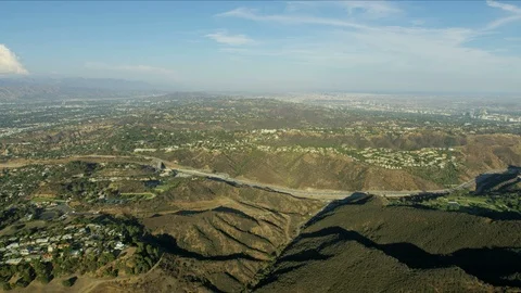 Aerial view freeway through mountain ranges Los Angeles Video stock 95988998