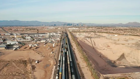 Aerial view of freight, cargo containers on railroad tracks in Las Vegas desert Stock Footage 121643801
