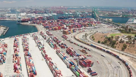 Aerial view of freight containers, trucks, Thomas Vincent Bridge, and cranes Stock Footage 200858533