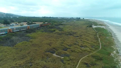 Aerial view of a freight train along the coastline 스톡 동영상 101667370