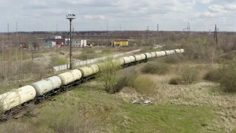 Aerial view of the freight train, carrying tank cars with oil, stands on the Stock Footage 170147023
