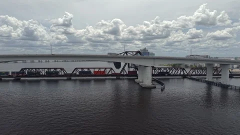 Aerial view of a freight train crossing a river bridge, United States. Stock Footage 335911749