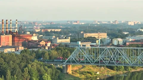 Aerial view. A freight train with many wagons travels over a railway bridge  Stock-Footage 234540099