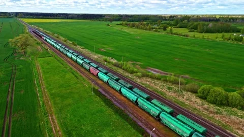 Aerial view of a freight train moving through green fields, Latvia. Stock Footage 340582587