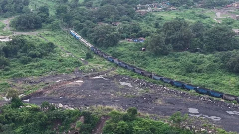 Aerial View of Freight Train Passing Through Rural Landscape 库存影片 330456756