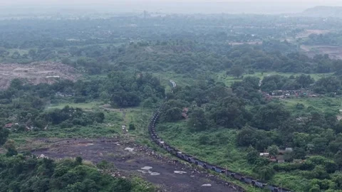 Aerial View of Freight Train Passing Through Rural Landscape Vídeos de archivo 330456846