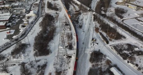 Aerial view of a freight train passing under power lines, United States. Stock Footage 334818908