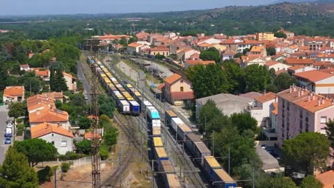 Aerial View of Freight Train Passing Through Residential Town With Orange Stock Footage 337229095