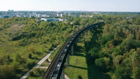 Aerial View of Freight Train Rides on Overpass Stock Footage 257834062