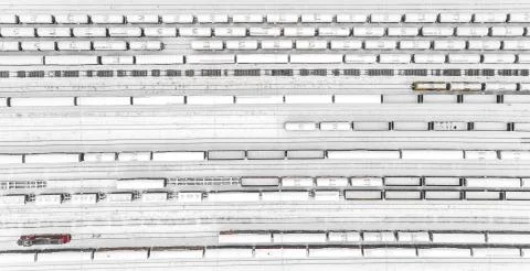 Aerial view of freight train yard covered in snow 库存照片