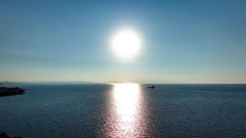 Aerial view of freighter sailing on open sea in evening sun landscape Stock Footage 248414373
