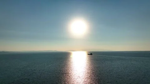 Aerial view of freighter sailing on open sea in evening sun landscape Stockbeeldmateriaal 248414414