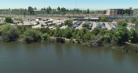Aerial view of Fremont BART train station, bus terminal, and parking lot. USA Stock Footage 312124034