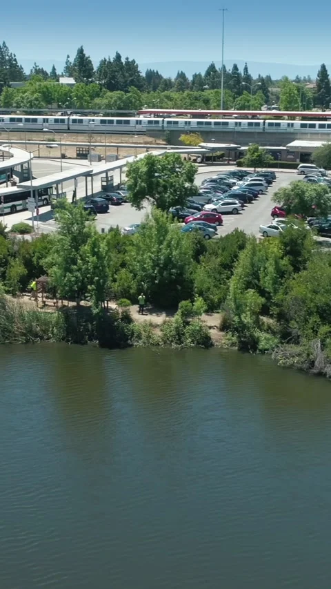 Aerial view of Fremont BART train station, bus terminal, and parking lot. USA Stock Footage 312125200